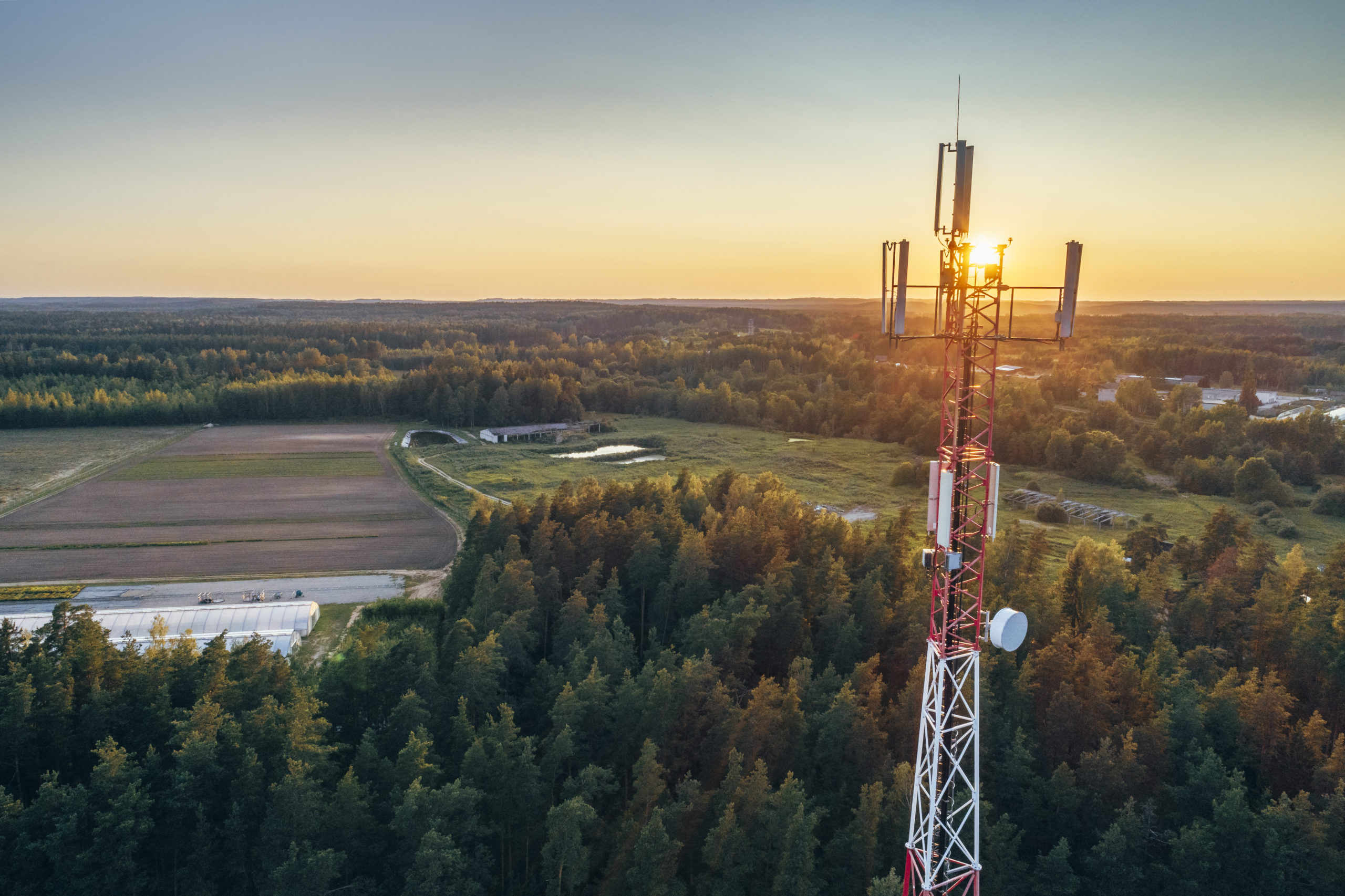 Mobile communication tower during sunset from above.